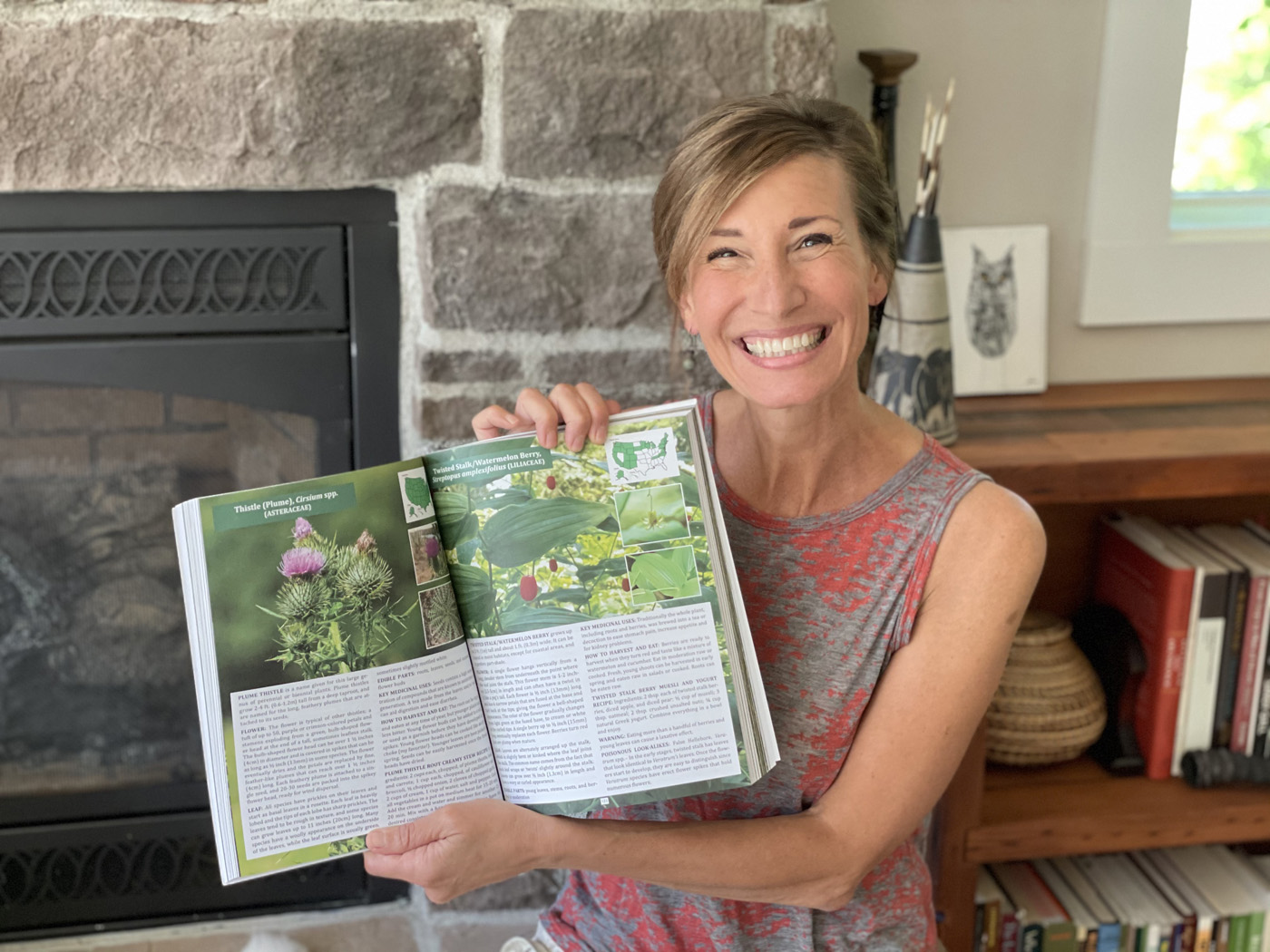 Nicole Apelian with tincture Nicole with wild foods book open