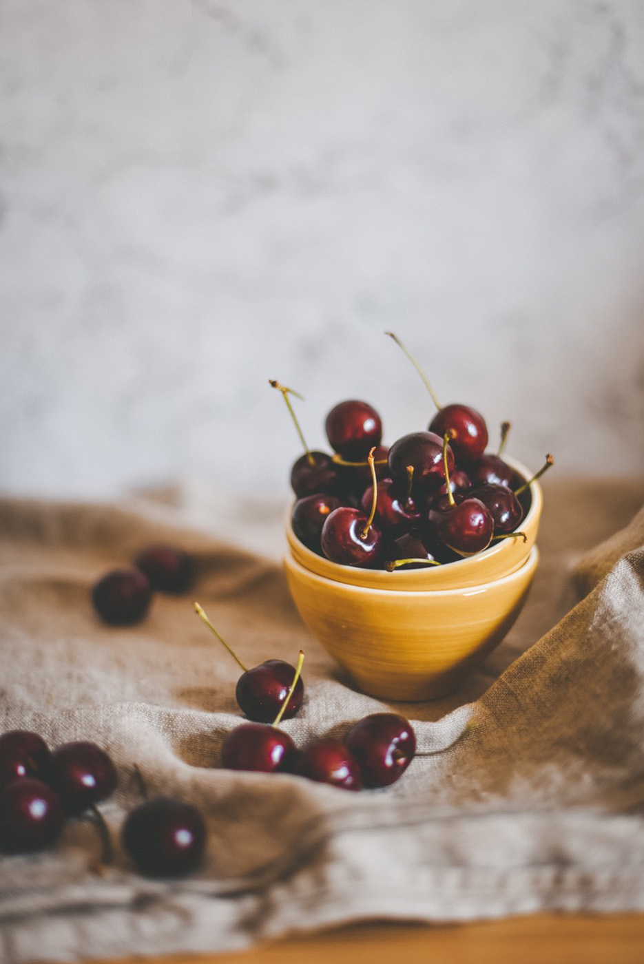 ripe black cherries in a yellow bowl ripe black cherries in a yellow bowl