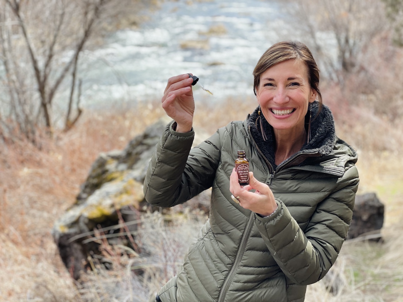 Nicole Apelian holding Reishi Tincture dropper and bottle Nicole Apelian holding Reishi Mushroom Tincture dropper and bottle