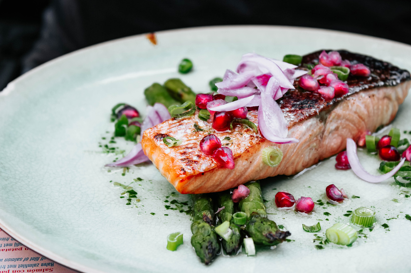 grilled salmon filet with asparagus onion and pomegranate seeds