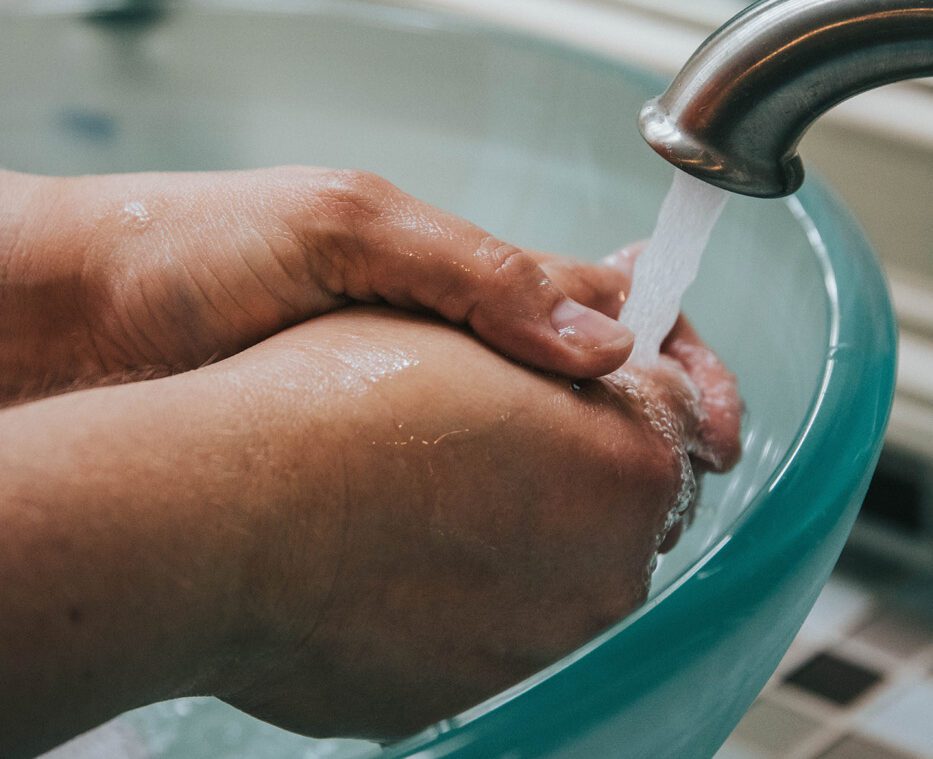 washing hands in glass sink