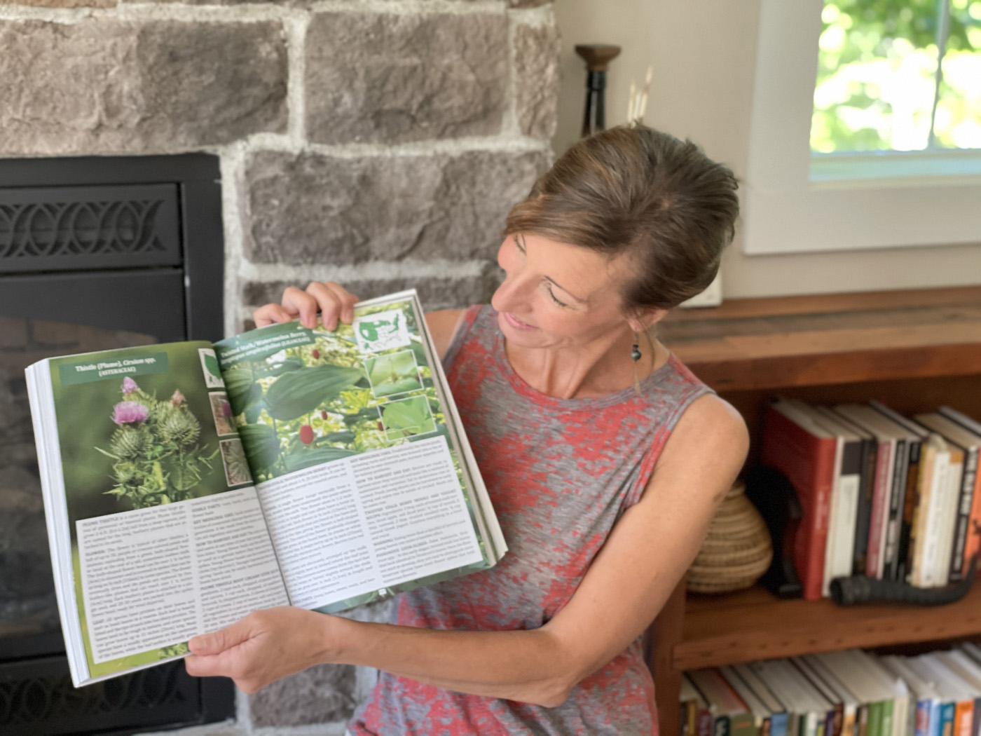 Nicole Apelian holding up a page of her Foraging Guide Nicole Apelian holding up a page of her Foraging Guide