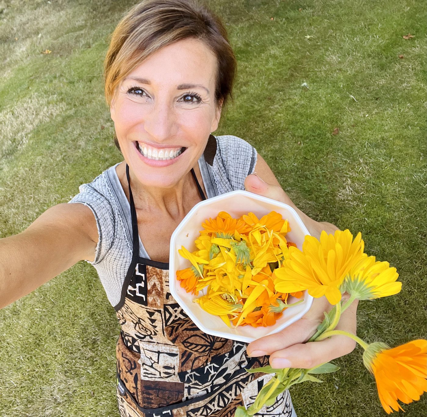Nicole Apelian calendula flower harvesting from her garden