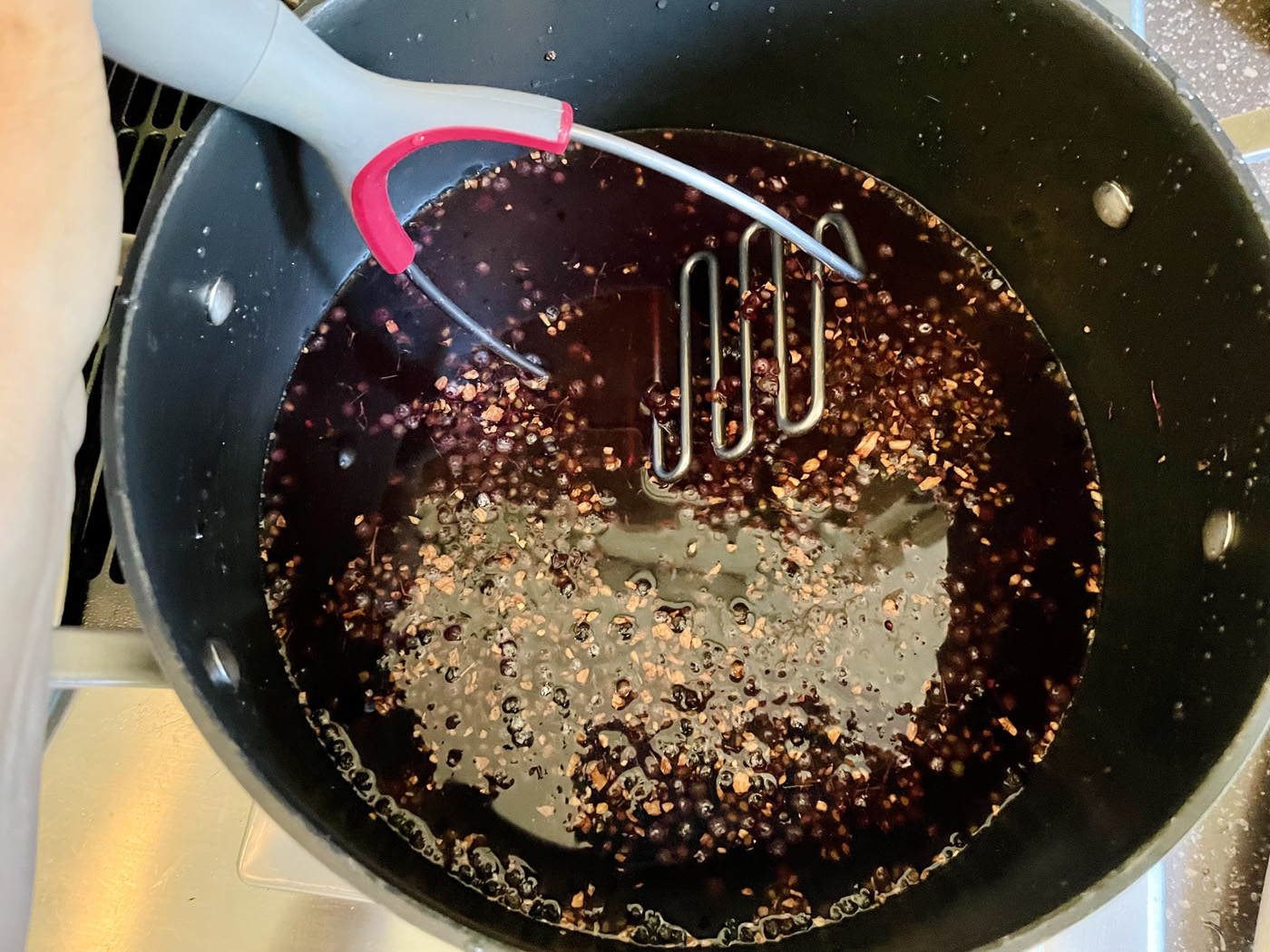 elderberry syrup in pot on stove elderberry syrup in pot on stove