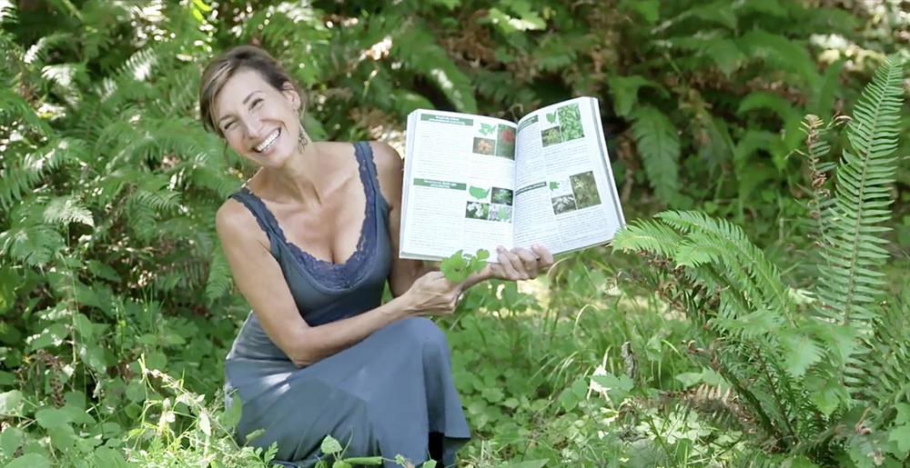 Nicole Apelian holding wild foods book open