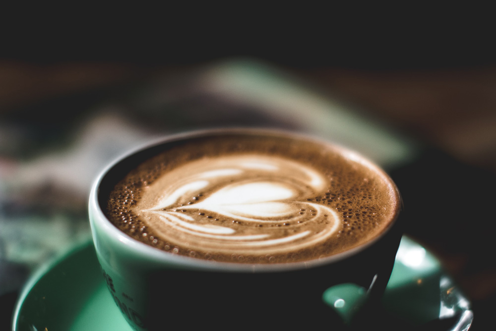 coffee art in green cup coffee art in green cup