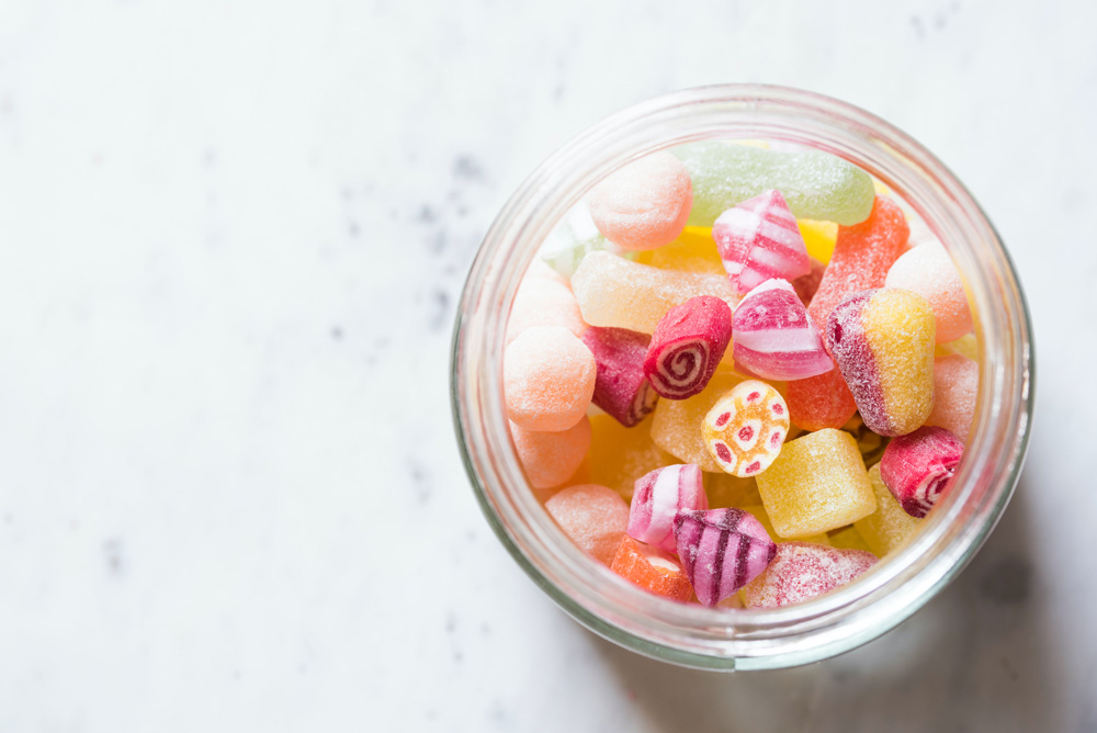jar of colorful sugary candy jar of colorful sugary candy