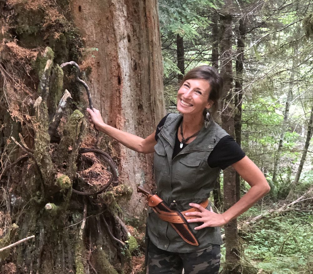 Nicole Apelian in woods with tree Need Another Reason to Enjoy Nature? Here are 5 New Science-Backed Benefits
