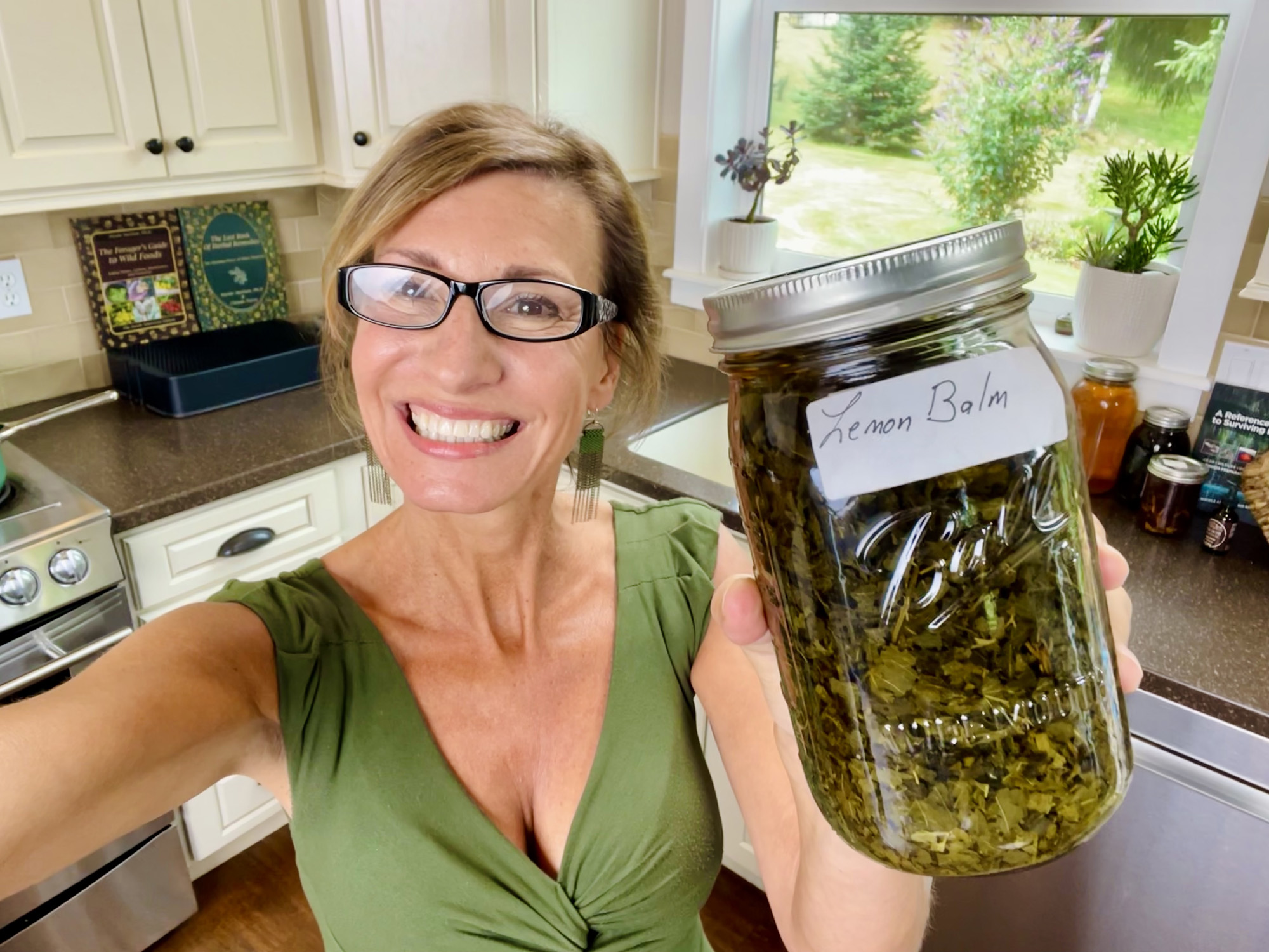 Nicole Apelian making lemon balm tincture in her kitchen Nicole Apelian making lemon balm tincture in her kitchen