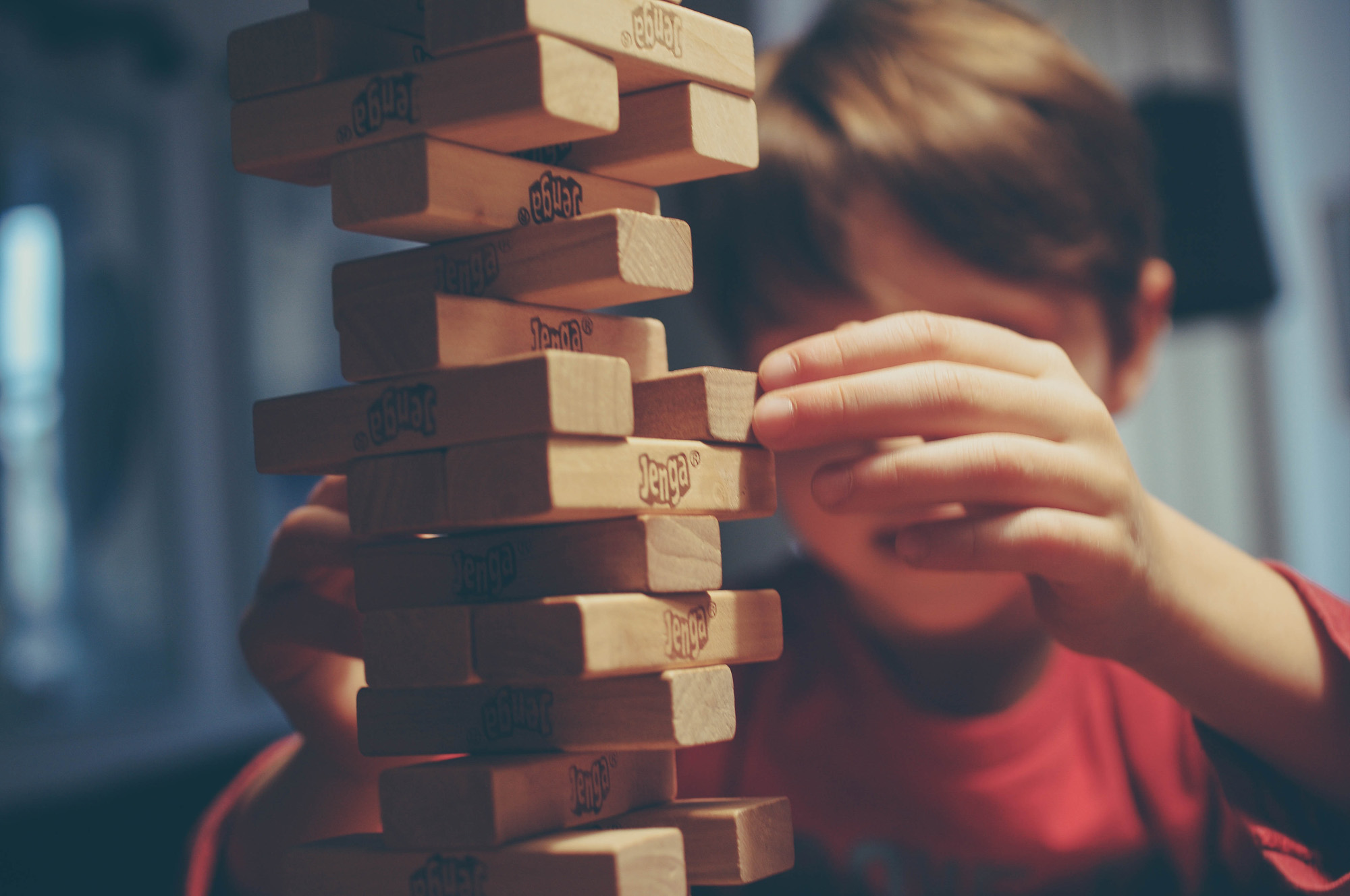 child playing jenga child playing jenga