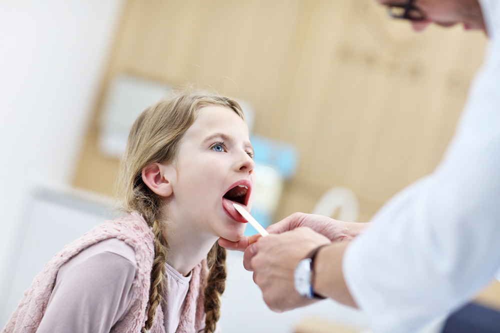 Little girl in clinic having a checkup with laryngologist Little girl in clinic having a checkup with laryngologist