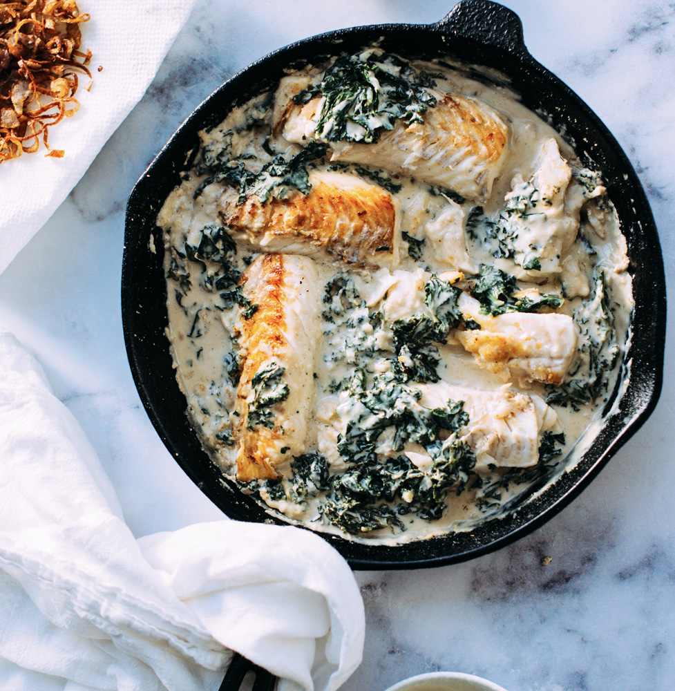 cast iron pan with fish spinach and cream sauce cast iron pan with fish spinach and cream sauce
