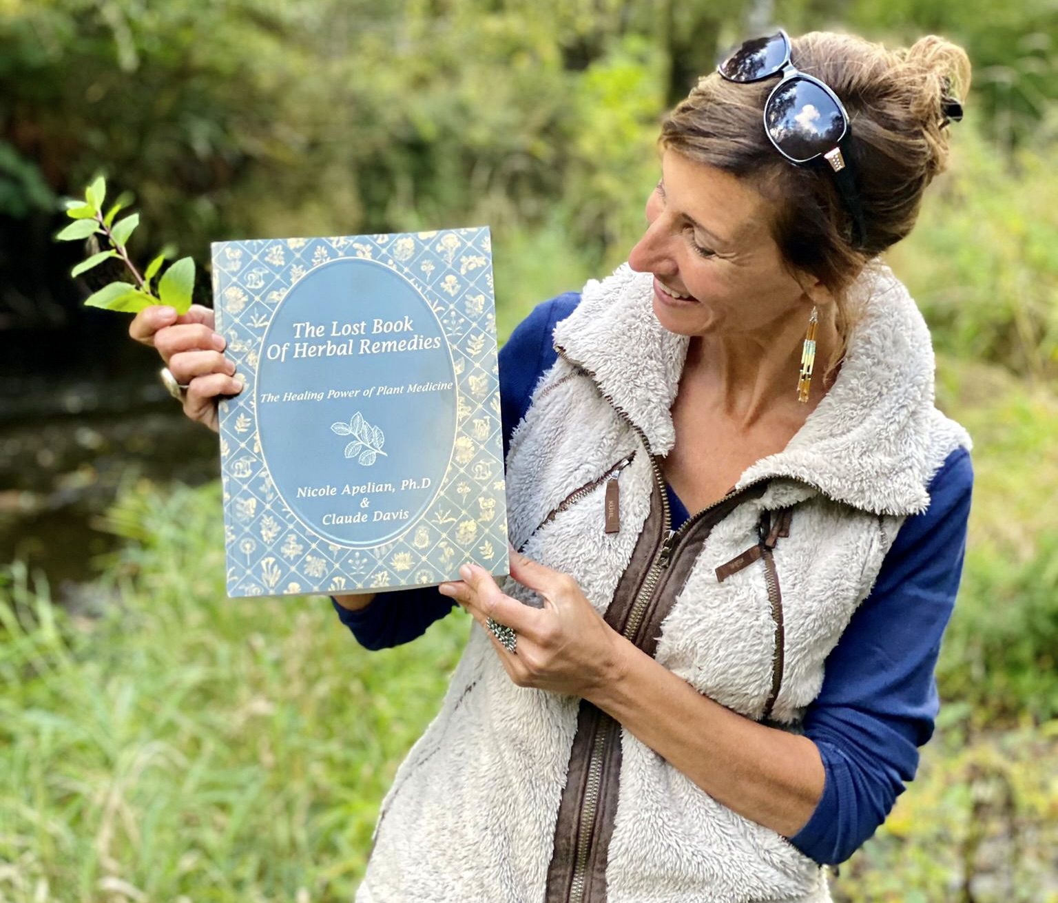 Nicole Apelian holding The Lost Book of Herbal Remedies Nicole Apelian holding The Lost Book of Herbal Remedies