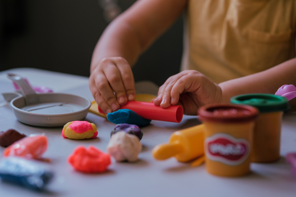 Toddler boy playing with play dough at home Toddler boy playing with play dough at home