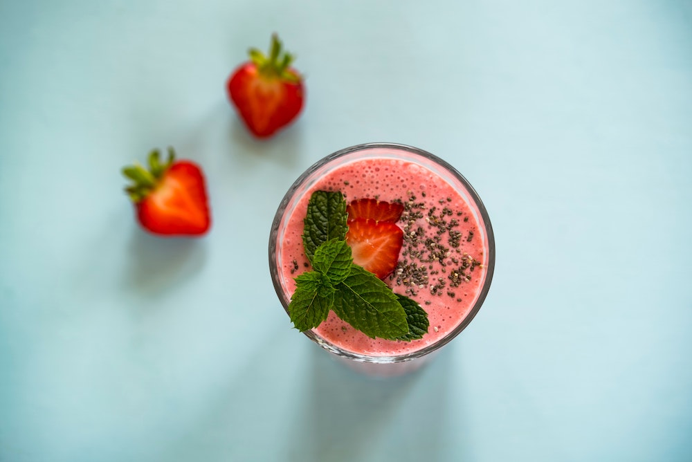 strawberry smoothie-blue background strawberry smoothie on a blue background