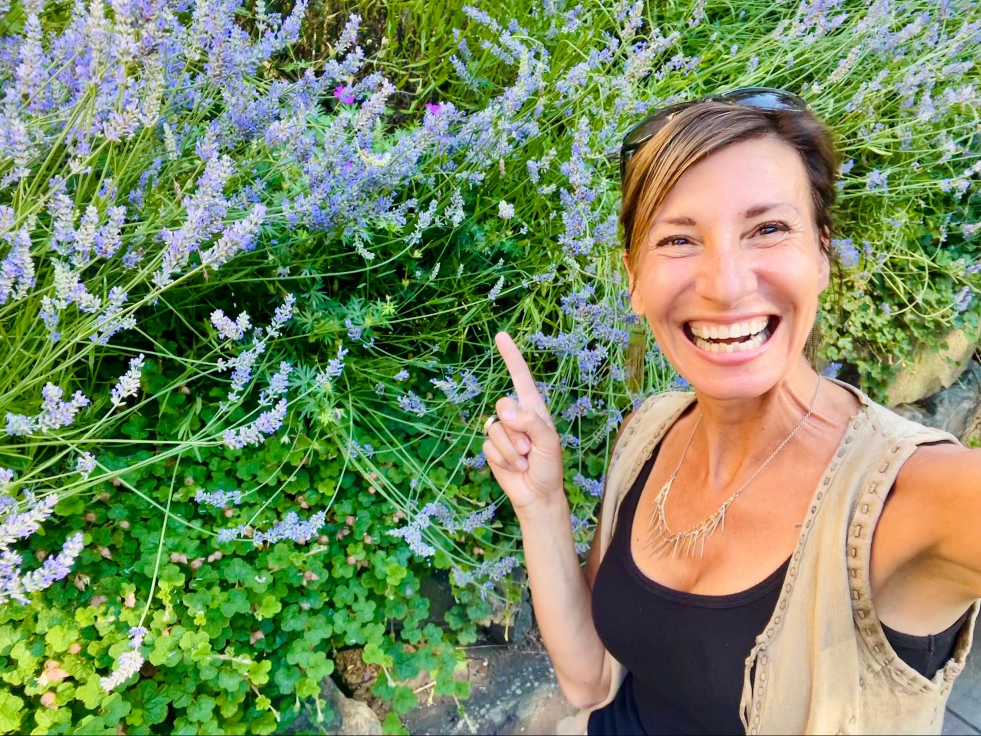 Nicole Apelian pointing at lavender flowers Nicole Apelian pointing at lavender flowers