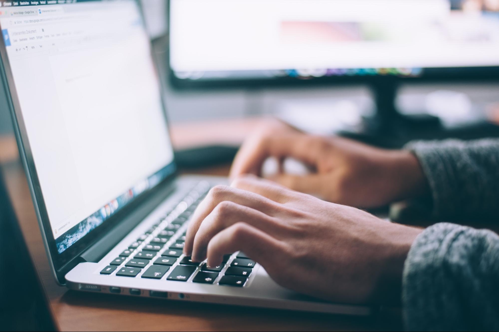 hands typing on laptop hands typing on laptop