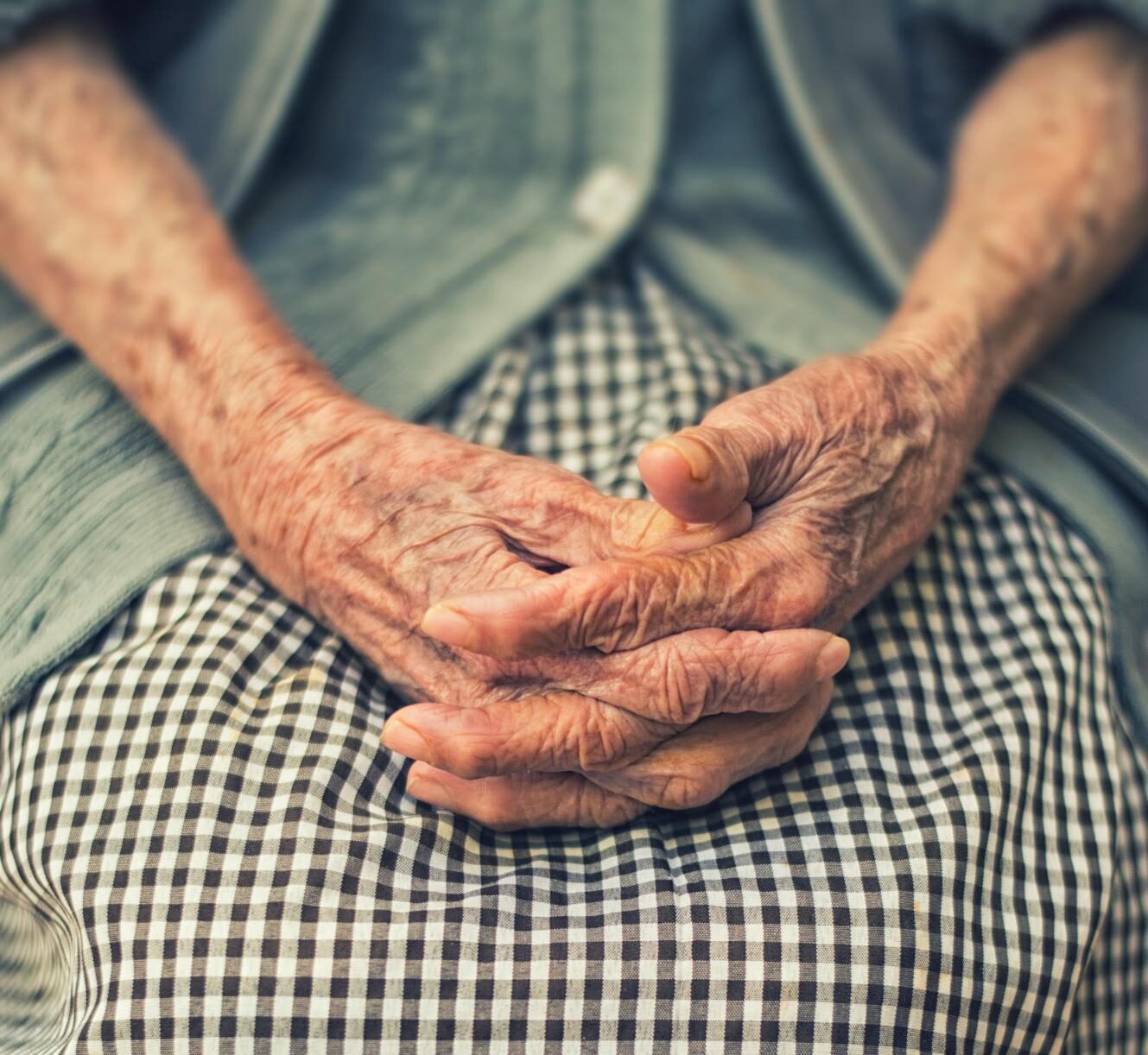 elderly woman with hands in lap elderly woman with hands in lap