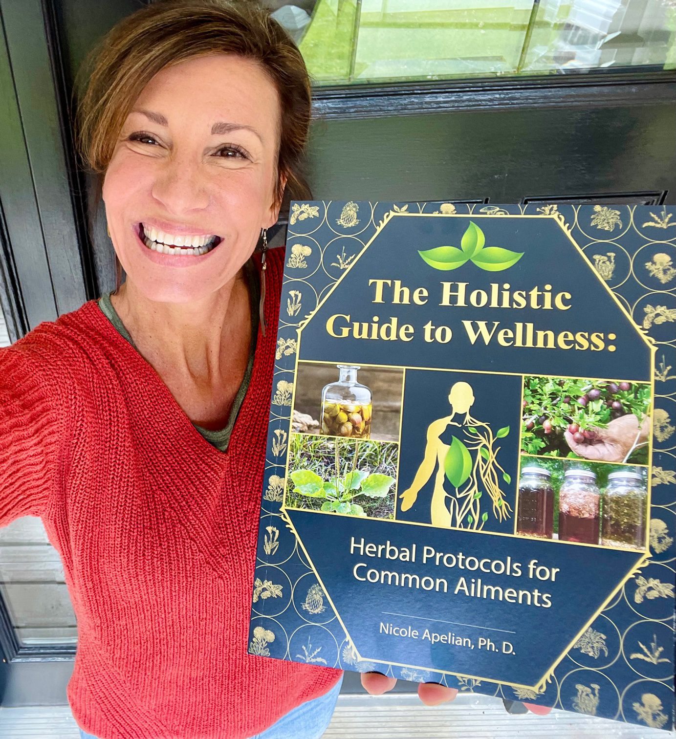 Nicole Apelian holding her Holistic Guide to Wellness book Nicole Apelian holding her Holistic Guide to Wellness book