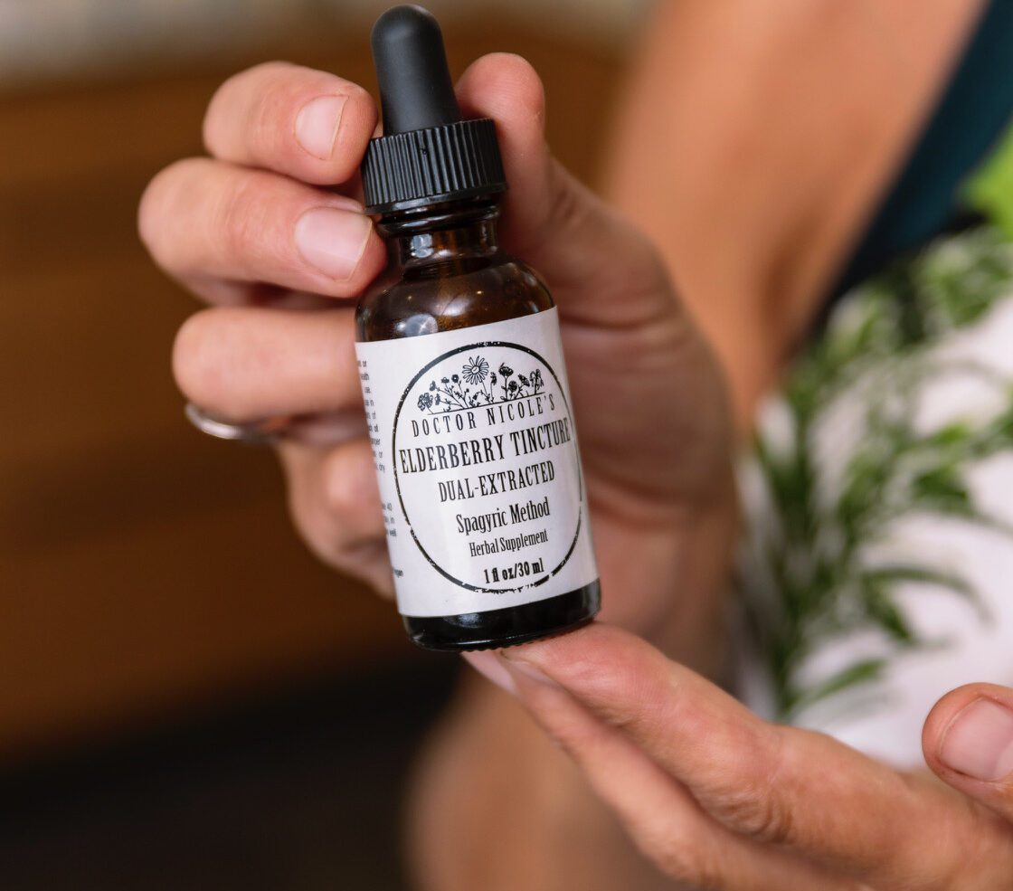 Nicole Apelian holding Nicoles Apothecary Elderberry Tincture Nicole Apelian holding Nicoles Apothecary Elderberry Tincture