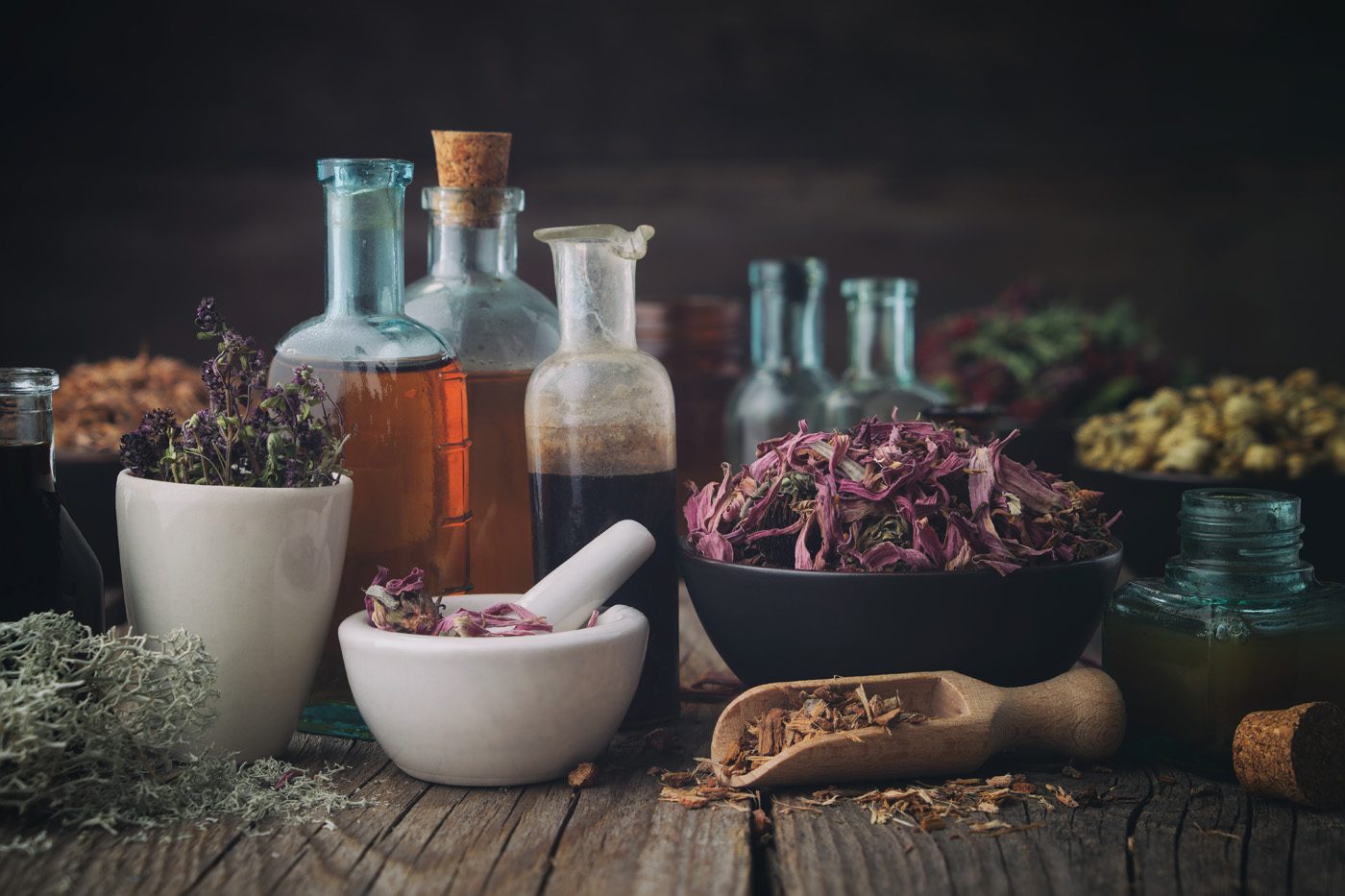 Bottles of healthy tincture or infusion, mortar and bowls of med Bottles of healthy tincture or infusion, mortar and bowls of med