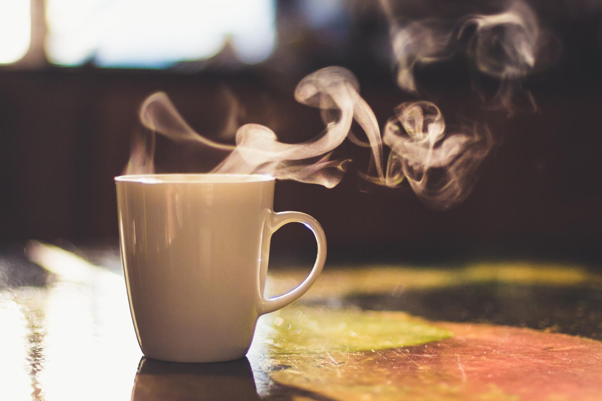 steam coming off mug of coffee steam coming off mug of coffee