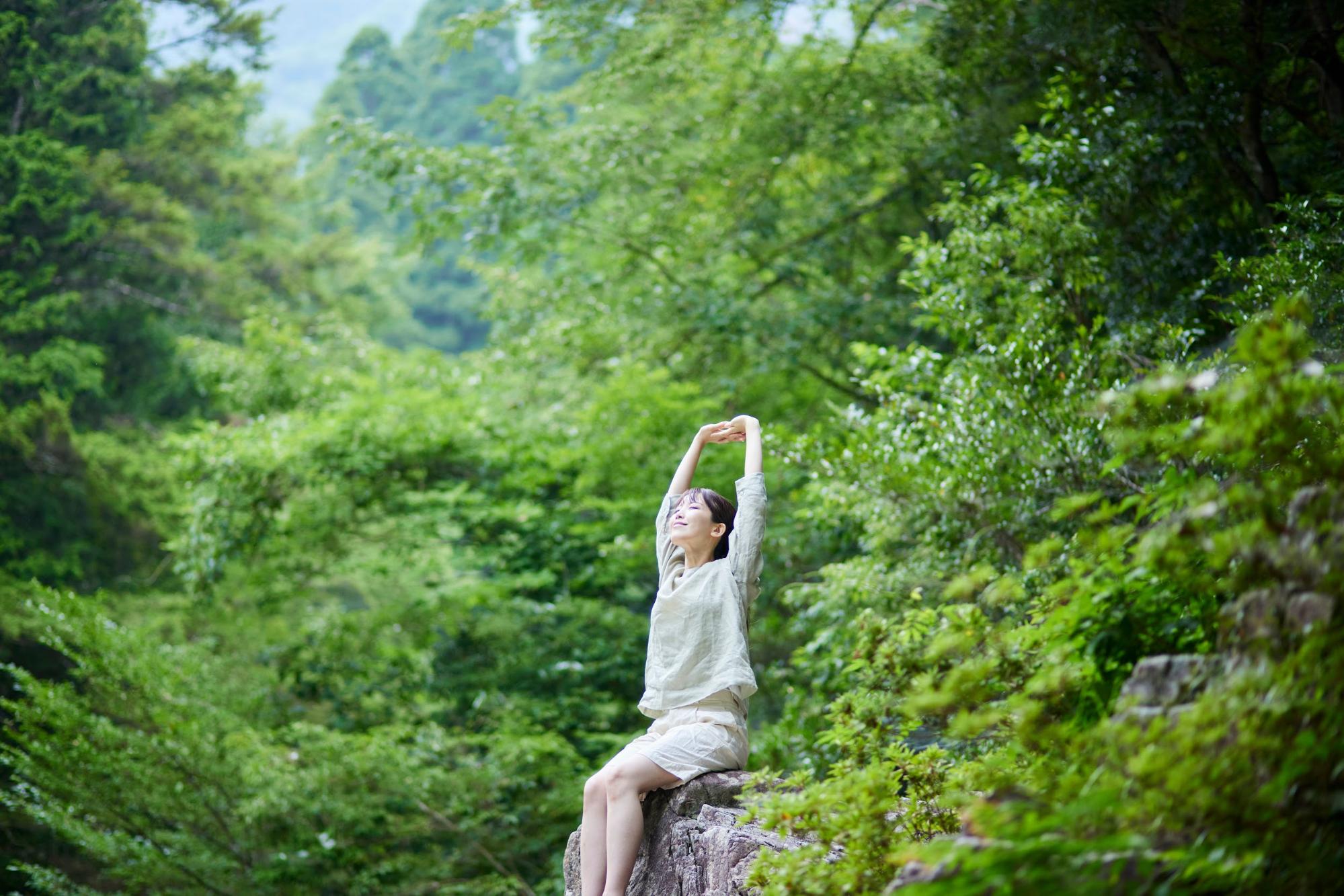 woman stretching in the woods woman stretching in the woods