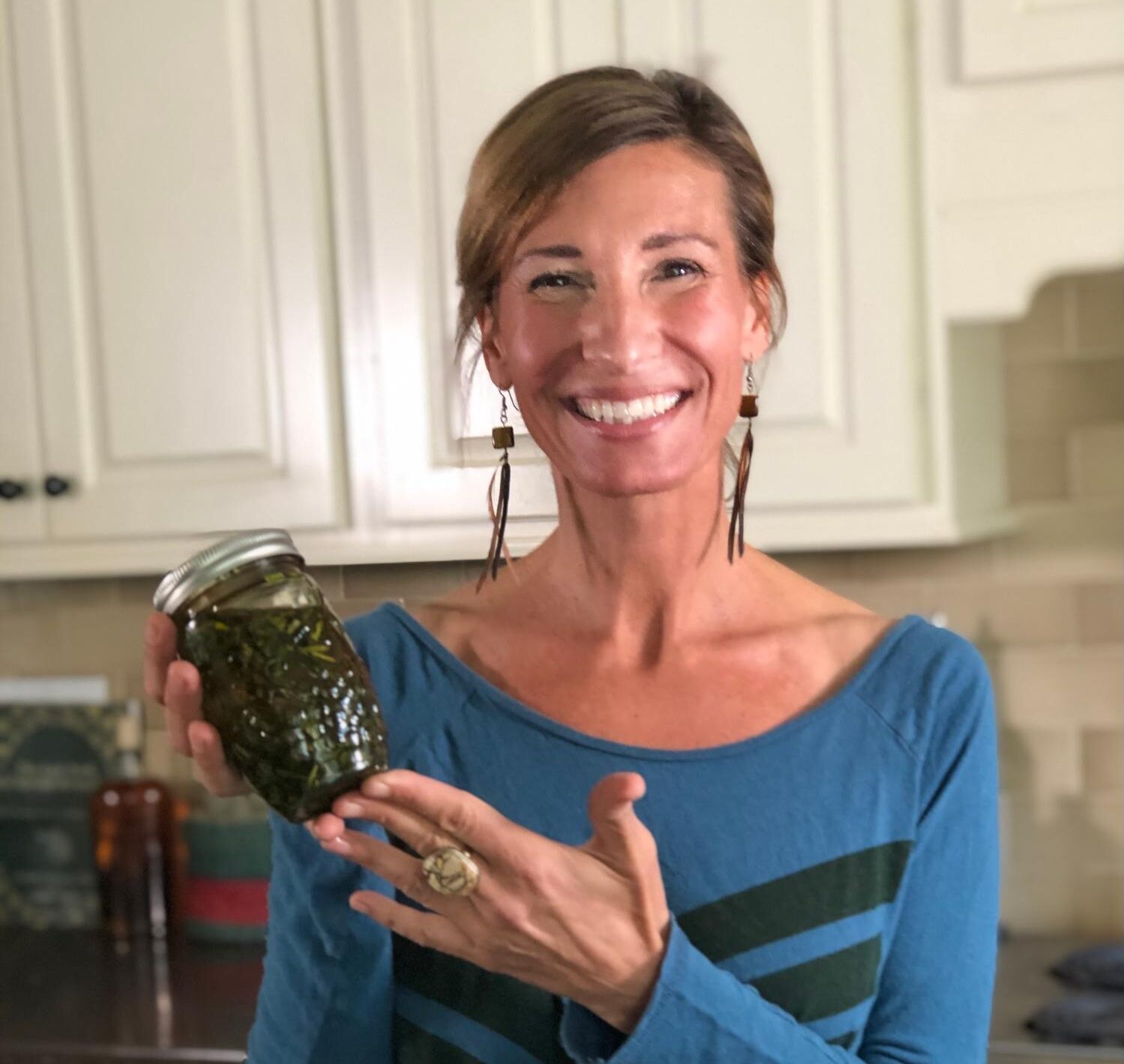 Nicole Apelian holding jar of homemade herbal remedies Prepping 101: Urban Dwellers
