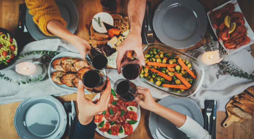 friends toasting over a Mediterranean diet meal