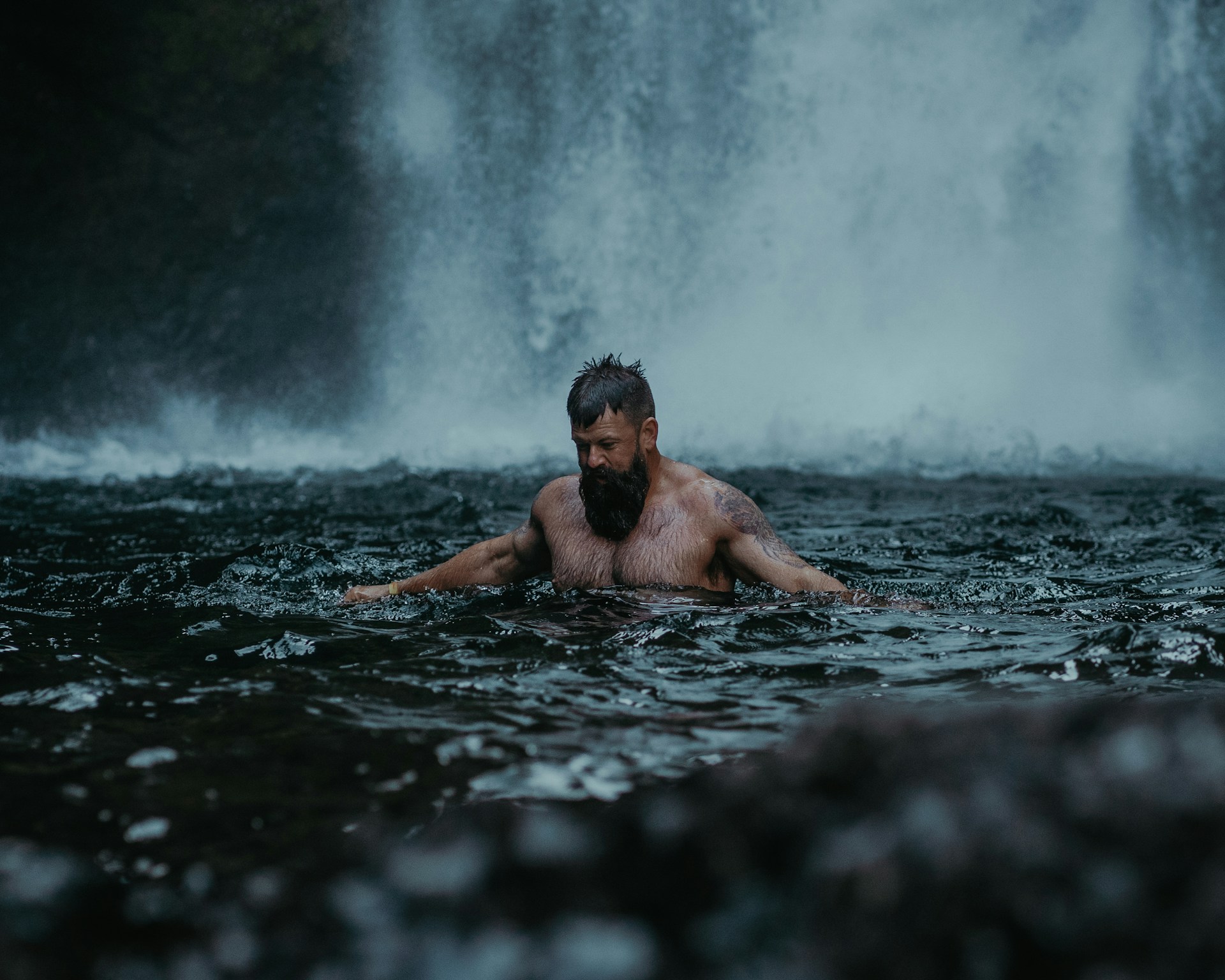 man bathing in waterfall pool man bathing in waterfall pool