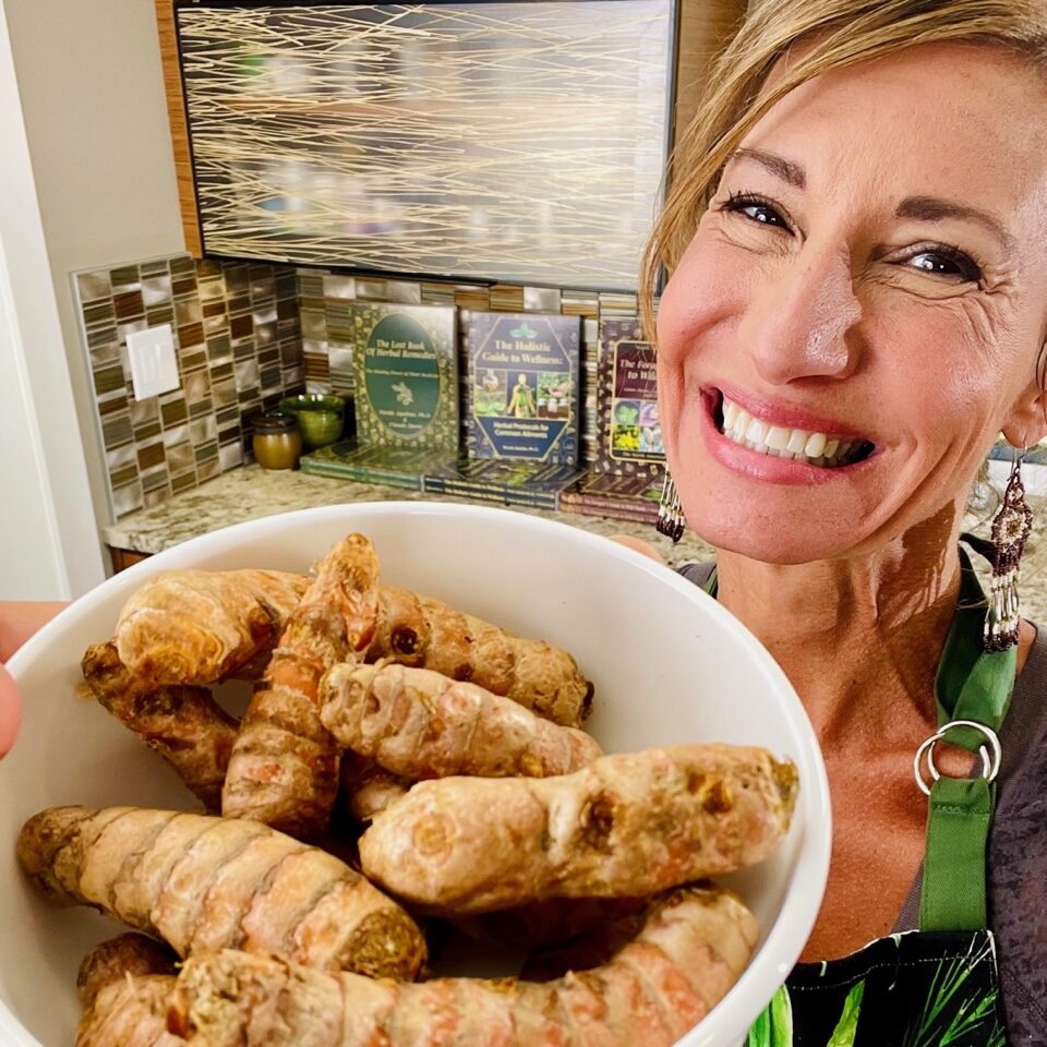 Nicole Apelian holding a bowl of ginger root