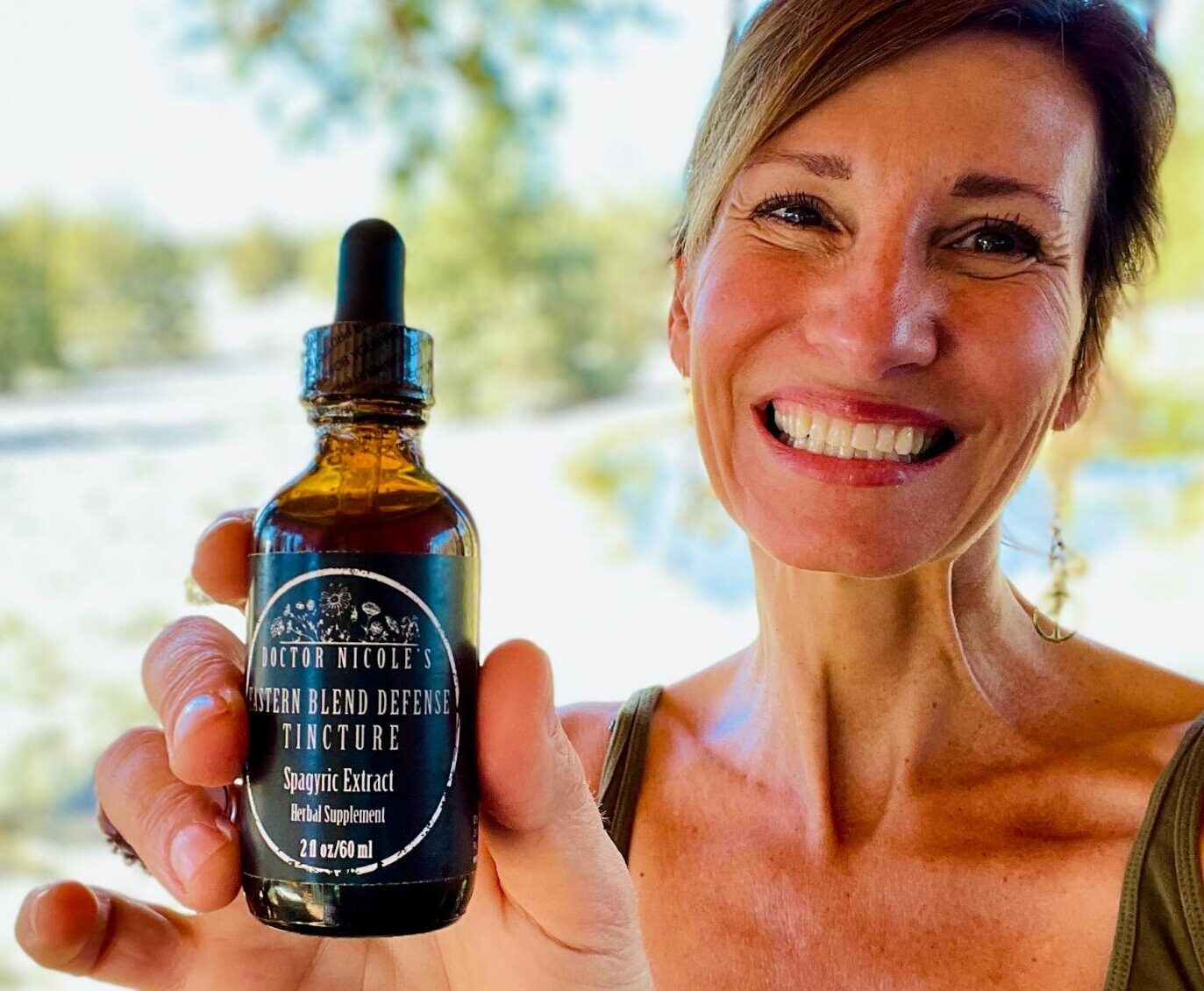 Nicole Apelian holding Eastern Blend Defense Tincture