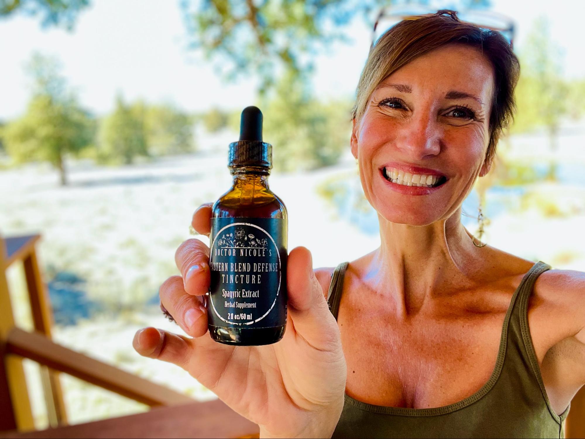 Nicole Apelian holding Eastern Blend Defense Tincture
