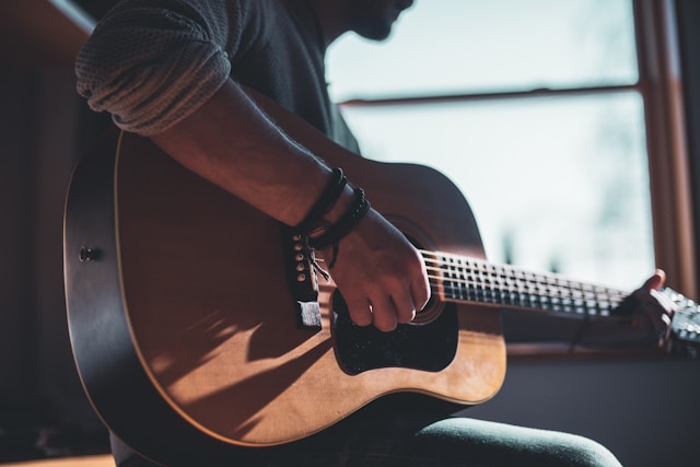 playing acoustic guitar playing acoustic guitar