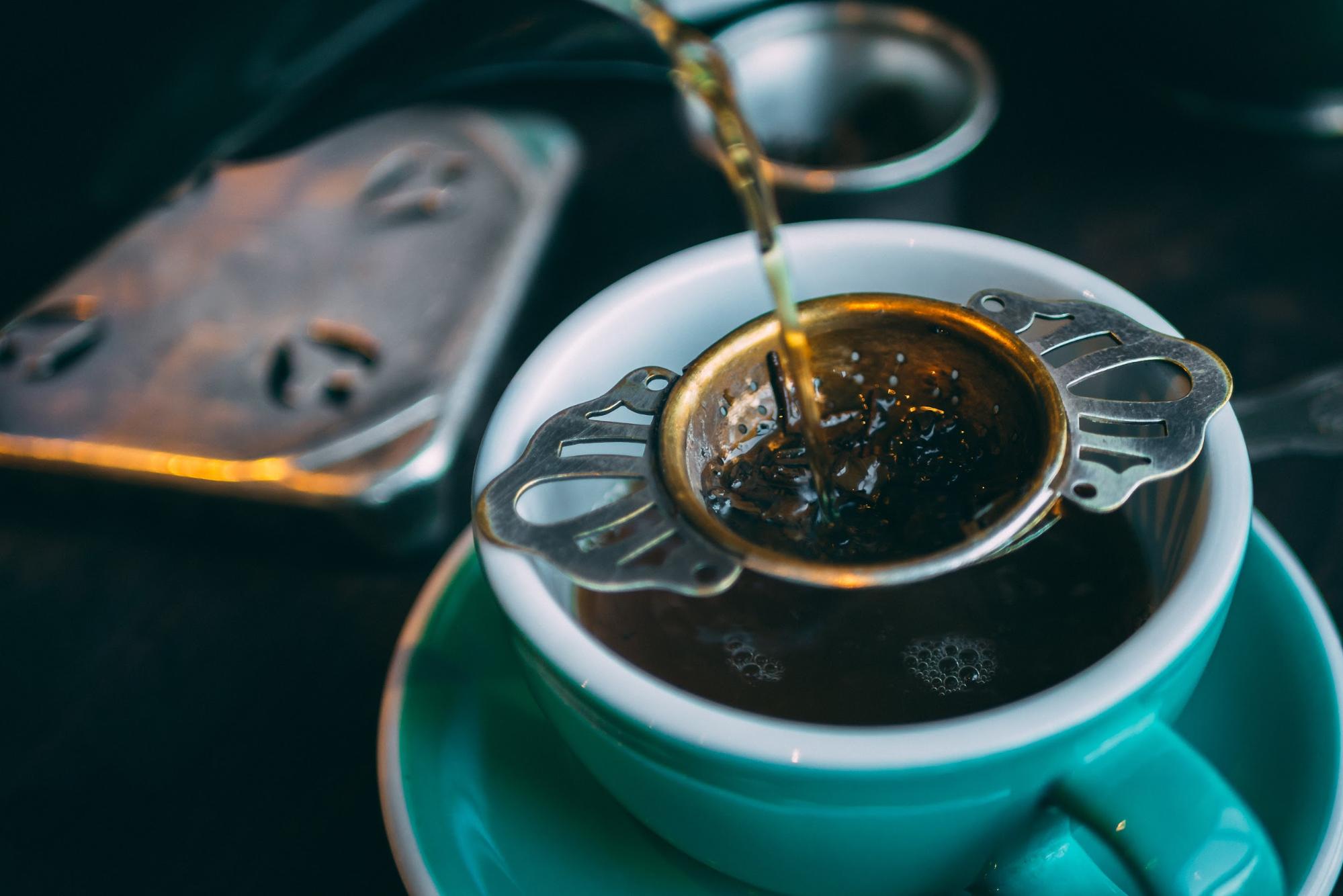 pouring water on tea leaves