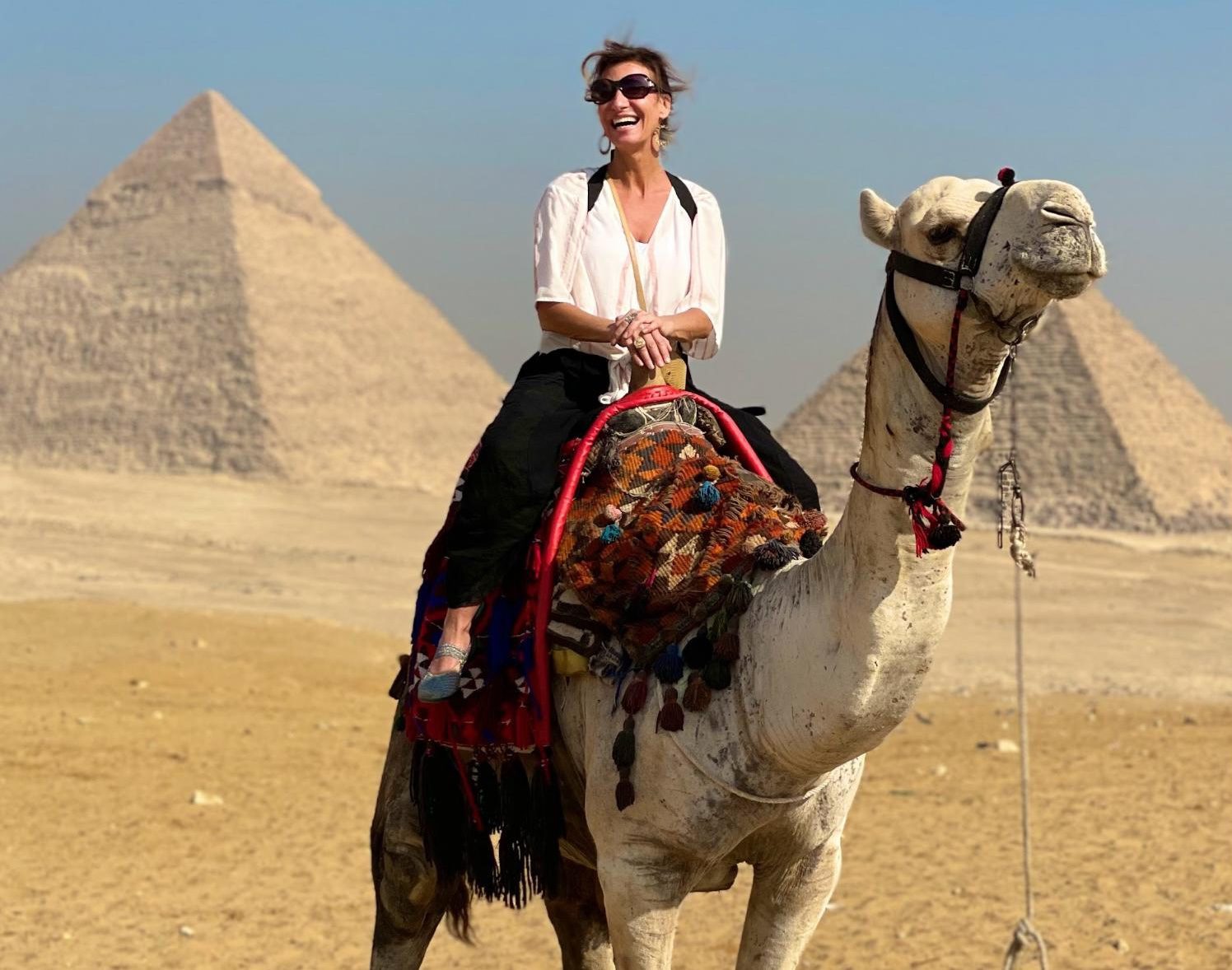 Nicole Apelian riding a camel at pyramids 5 Science-Backed Reasons Why Traveling is Good For You