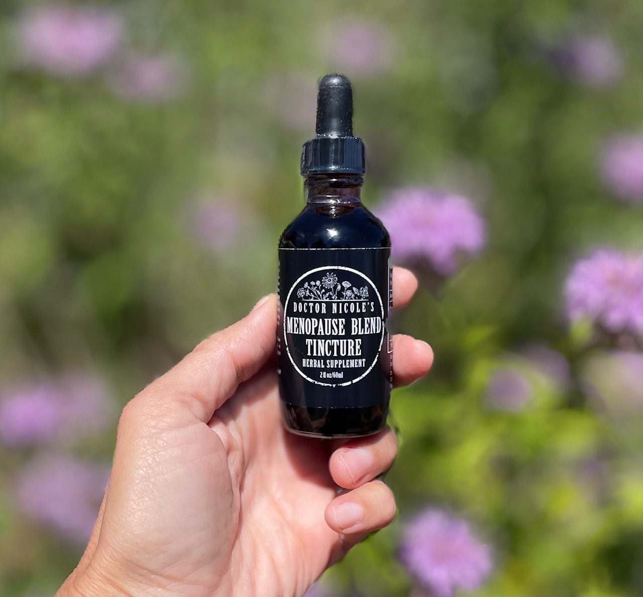 hand holding Nicole's Apothecary Menopause Blend Tincture hand holding Nicole's Apothecary Menopause Blend Tincture
