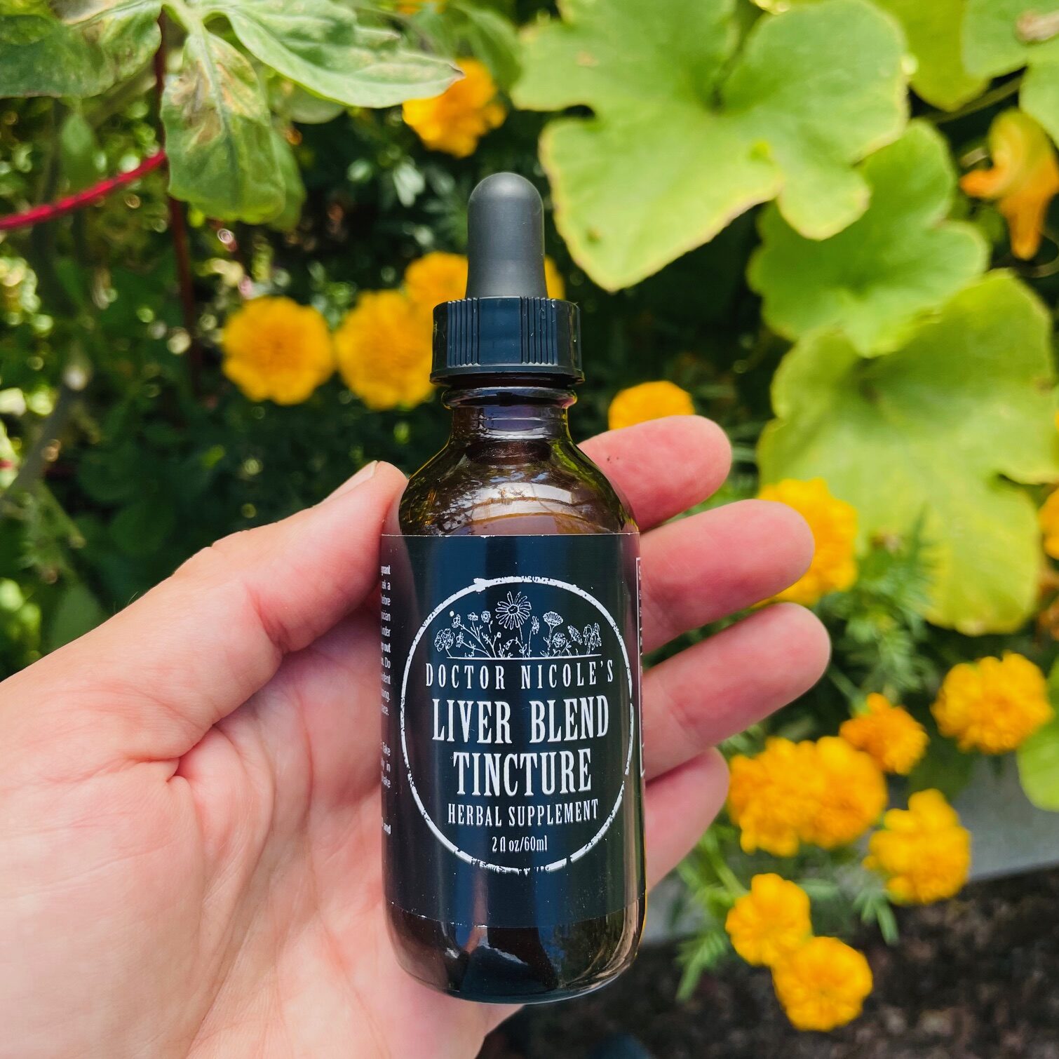 hand holding Liver Blend tincture