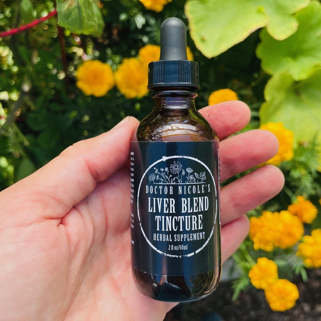 Nicoles Apothecary Bronchial Blend tincture hand holding Liver Blend tincture