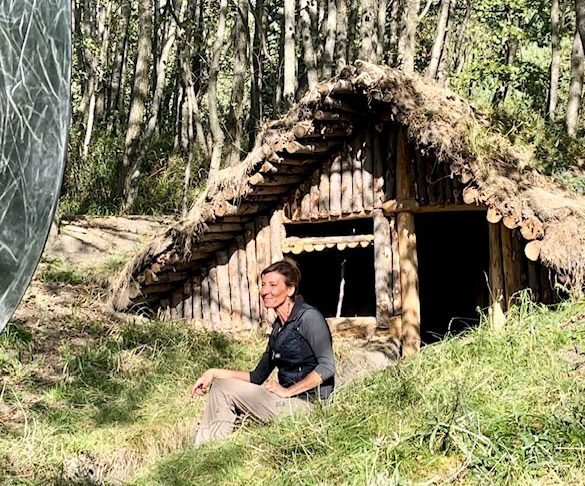 Nicole Apelian in front of long term shelter Long-Term Living in the Wild: The Art of Shelter Building