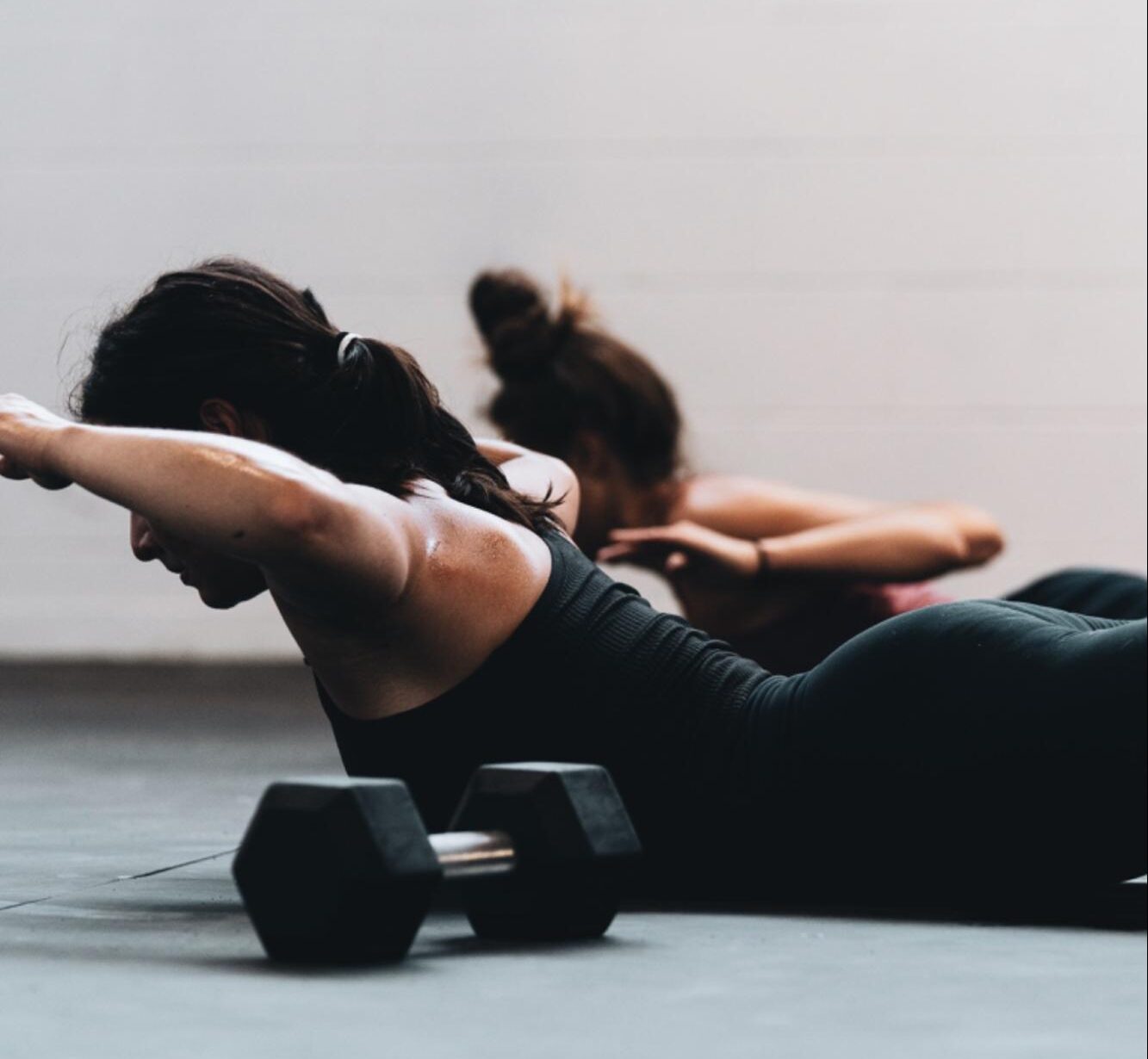 women doing bodyweight floor exercise