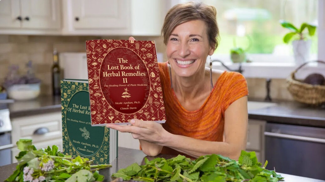 Nicole Apelian holding The Lost Book of Herbal Remedies II