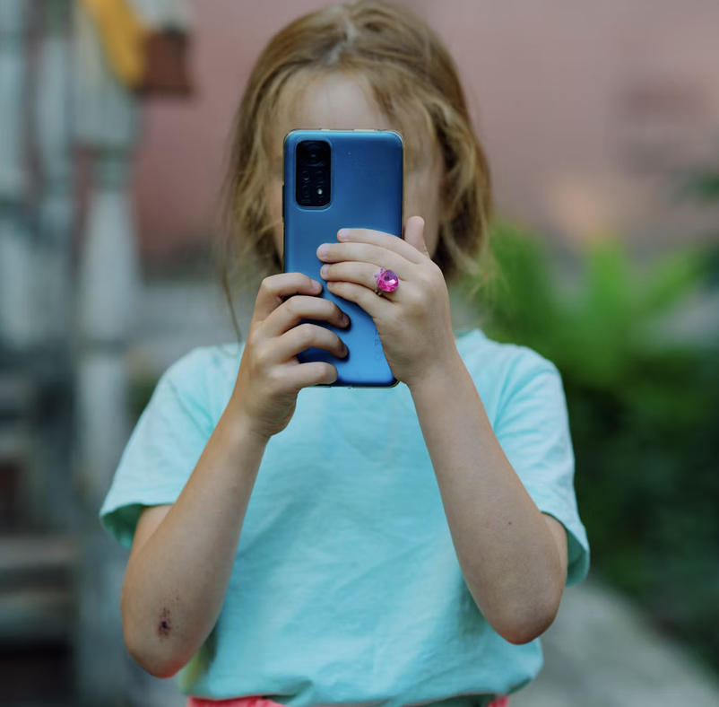 young girl holding cellphone