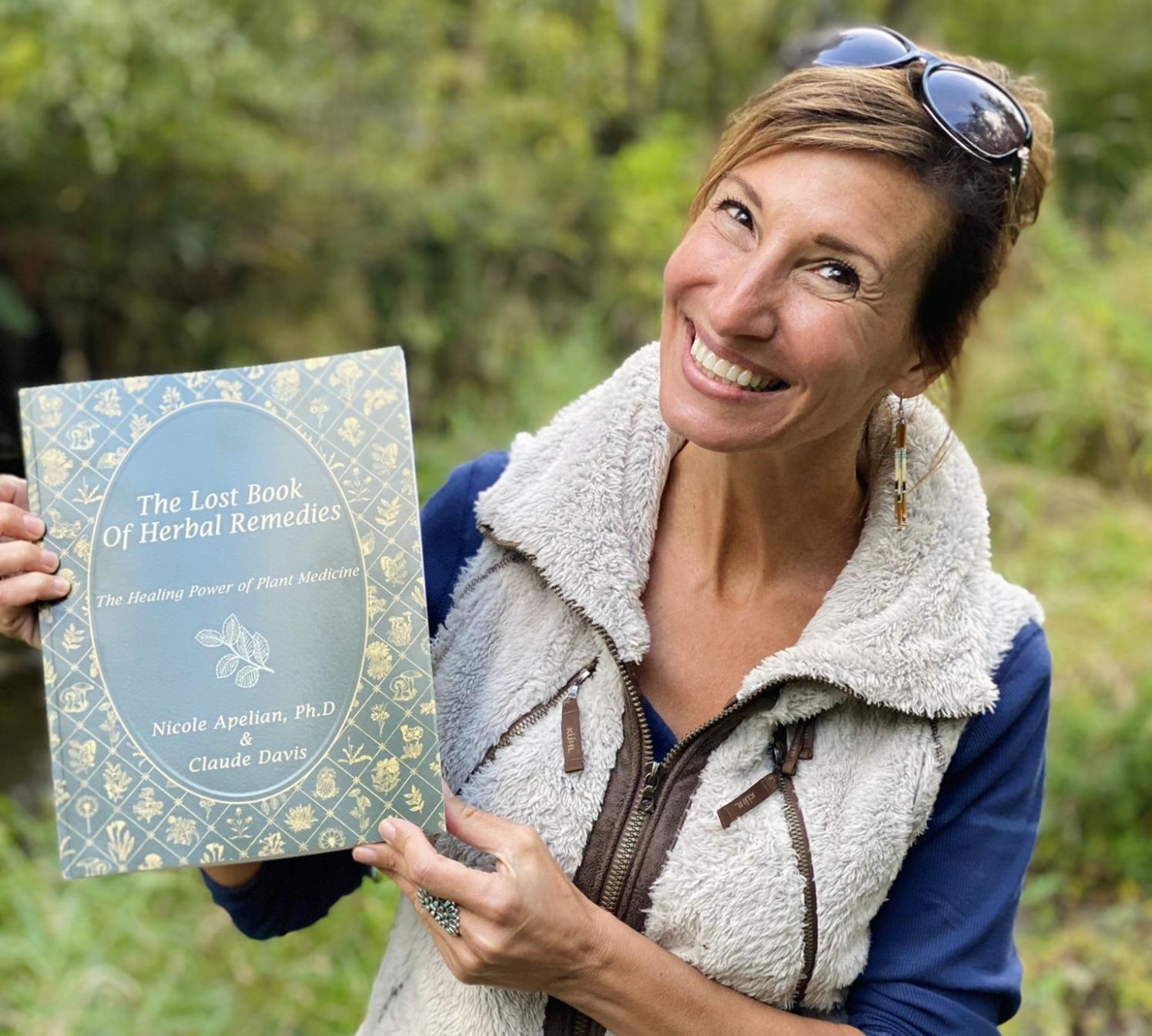 Nicole Apelian holding Lost Book of Herbal Remedies