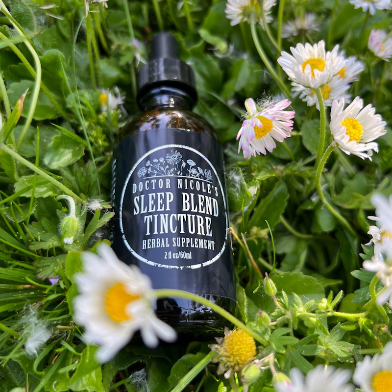 Nicoles Apothecary Sleep Blend Tincture in bed of chamomile