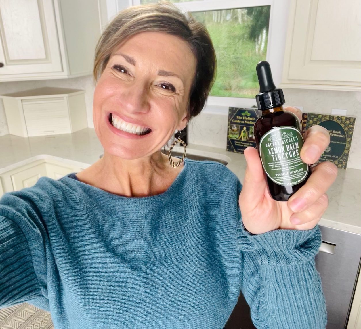 Nicole Apelian lemon balm tincture Nicole Apelian holding bottle of her Lemon Balm Tincture