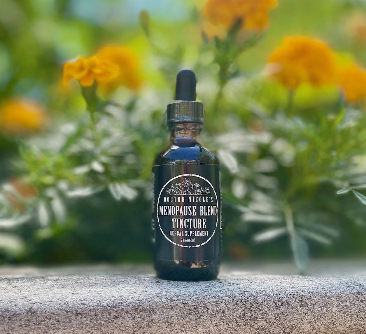 Nicoles Apothecary Menopause Blend Tincture Nicoles Apothecary Menopause Blend Tincture in front of marigolds